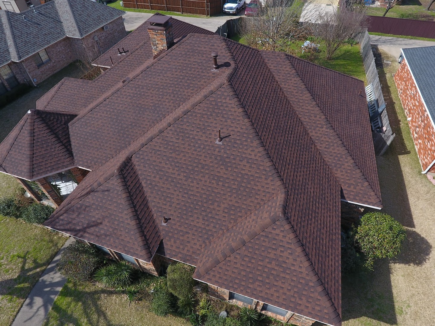 Aerial view of completed brown shingle roof