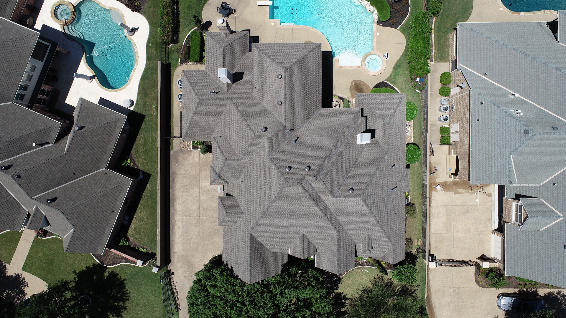 Aerial top-down view of completed grey shingle roof
